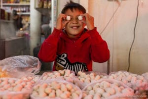 Shymkent, food market, kid playing with cheese balls