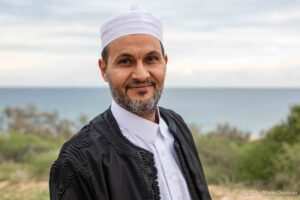 Man in traditional outfit at Leptis Magna